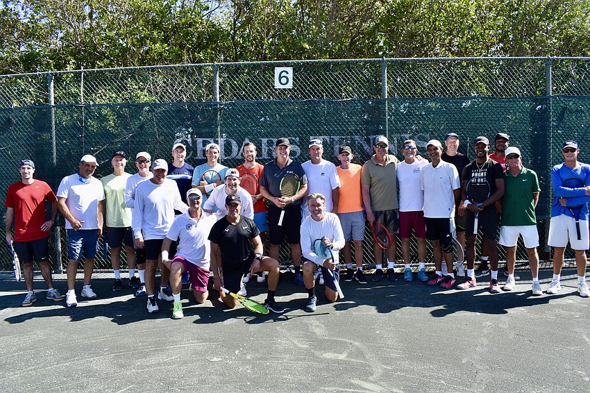 Coaches, clinic participants and organizers stand for a team photo before the tennis began.