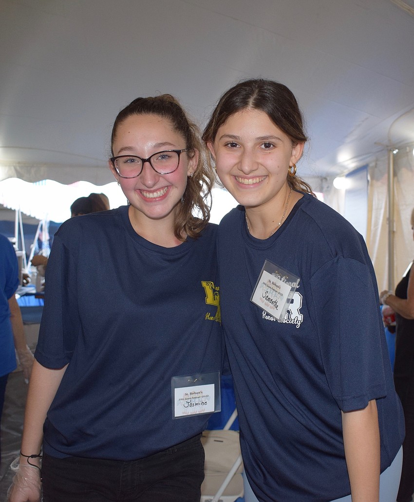 Lakewood Ranch High School junior Jasmine Burden and senior Samantha Greenfield volunteer at the Greek Glendi festival. Both the volunteers look forward to trying the different foods and pastries available.