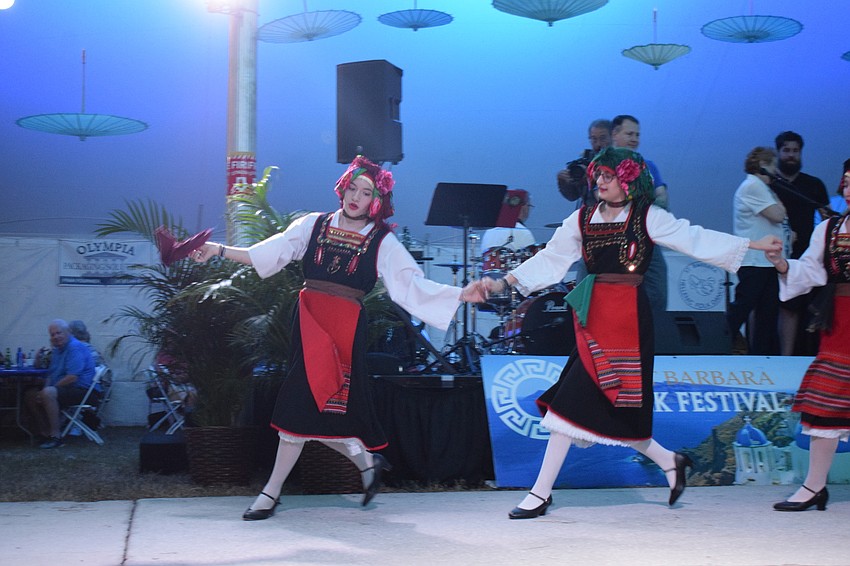 Demitria Guimond and Breana Nasser perform a traditional Greek dance with the Hellenic dance group.