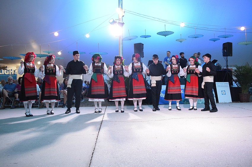 A group of Hellenic dancers perform for the crowd.