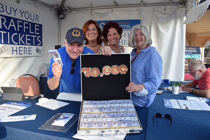 Greek Glendi volunteers George Pandis, Jean Rebel, Merryl Coven and Joan Alexander encourage people to buy raffle tickets to hopefully win a Mercedes Benz.
