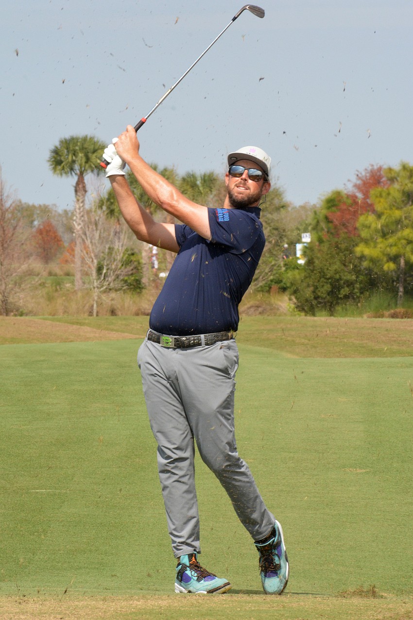 Brad Brunner kicks up grass with a shot on the No. 8 hole during round three of the 2022 LECOM Suncoast Classic at Lakewood National Golf Club.