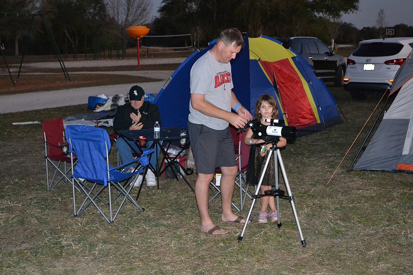 Matt Keever, Craig Fischer, and Hope Keever Fischer prepare for a night of stargazing under a full moon.