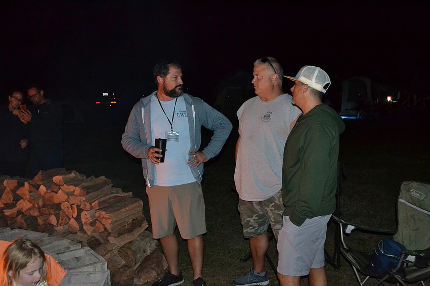 Lakewood Ranch Community Activities Executive Director Keith Pandeloglou and event volunteers Daryl Haworth and Michael Bugel, kick back at the campfire.