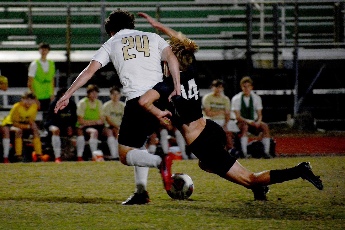 Lakewood Ranch High senior Johnathan Kline (14) gets dragged down by Plant junior Will Anderson (24).