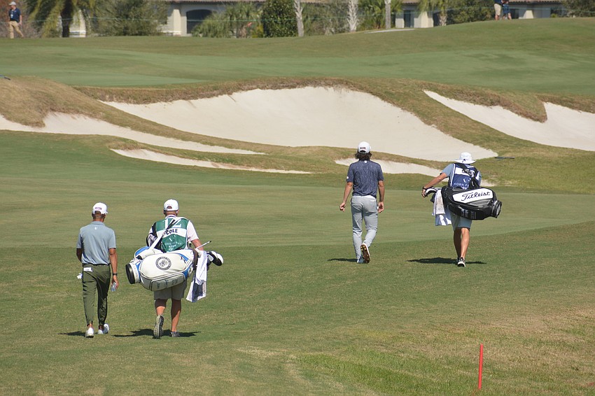 Eric Cole, Callum Tarren and their caddies walk down the fairway of the No. 9 hole during the final round of the 2022 LECOM Suncoast Classic at Lakewood National Golf Club.