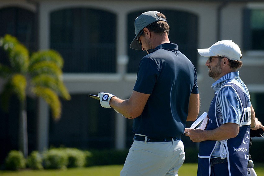 Scott Harrington checks his notes on the No. 9 hole during the final round of the 2022 LECOM Suncoast Classic at Lakewood National Golf Club.