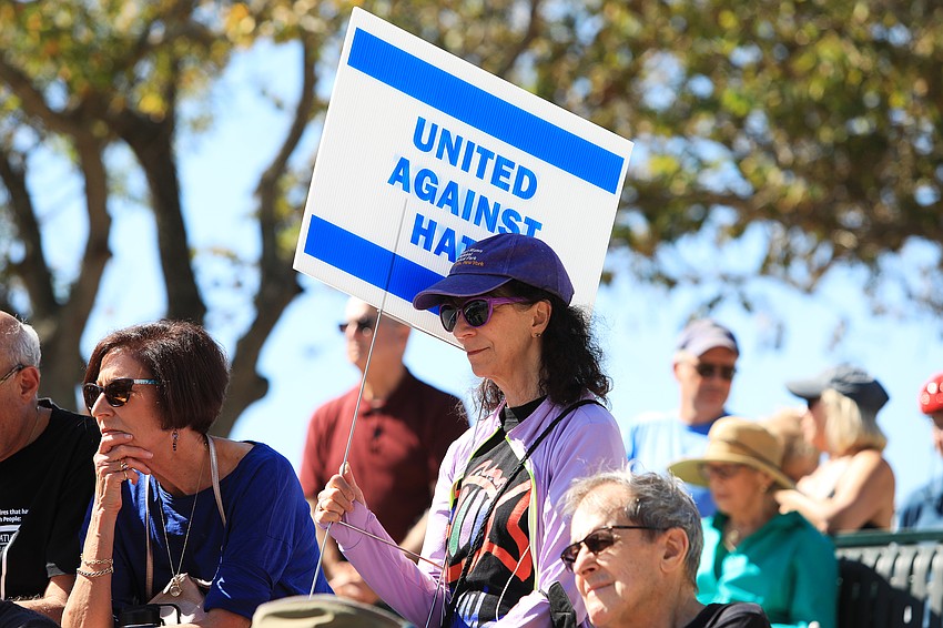 Carolyn Michel uses her sign for shade.