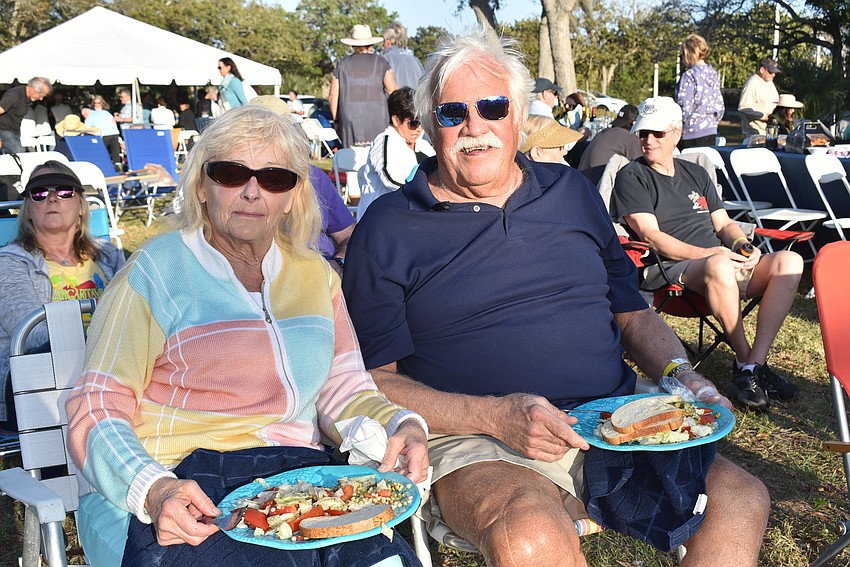 Miriam and Mike Russell balanced picnic plates on their laps.