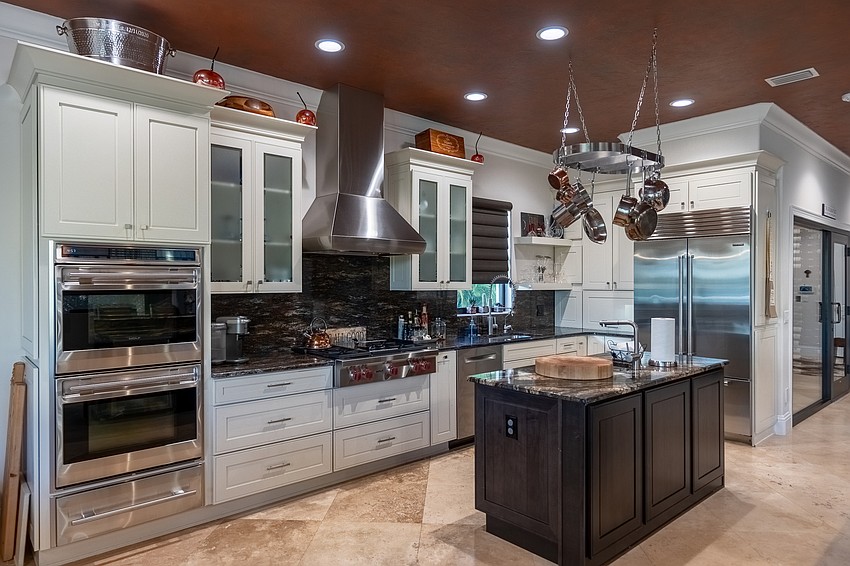 The custom chef's kitchen includes a Wolf double oven and a Sub Zero refrigerator.