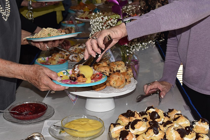 Lois Lowsky gets a pastry from Robin Green.