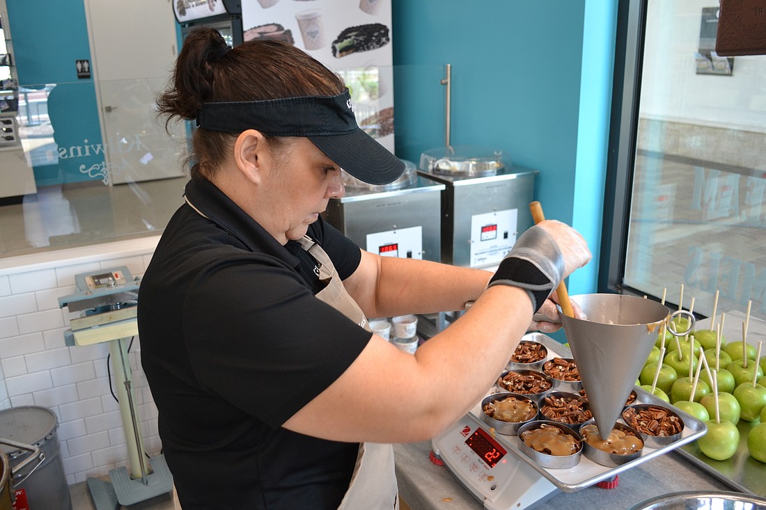 Tricia Farrington focuses all her attention on making pecan caramel apples