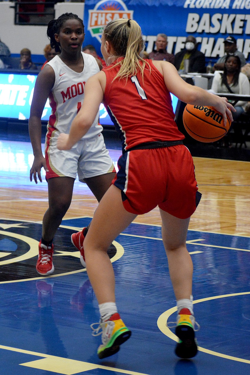 Mooney freshman Sy'monique Simon guards Westminster senior Claire Erickson (1).