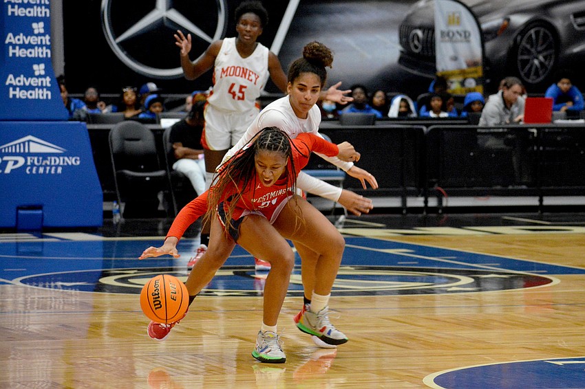 Mooney freshman Kali Barrett causes Westminster junior Taelyn Carey to lose control of the ball.