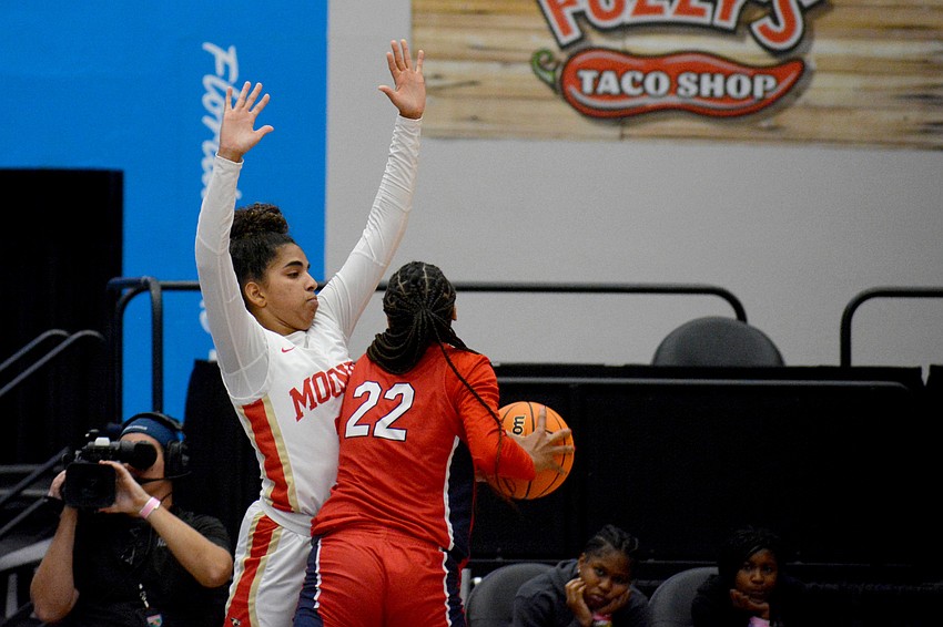 Mooney freshman Kali Barrett protects the post from Westminster junior Taelyn Carey.