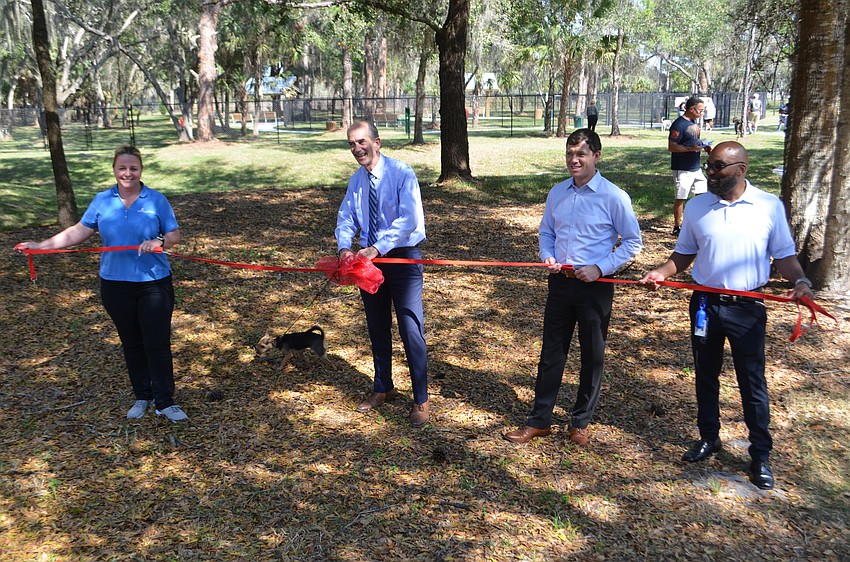 From left: Sarasota County Parks, Recreation and Natural Resources director Nicole Rissler leads an unleashing moment for Bay Street Dog Park.