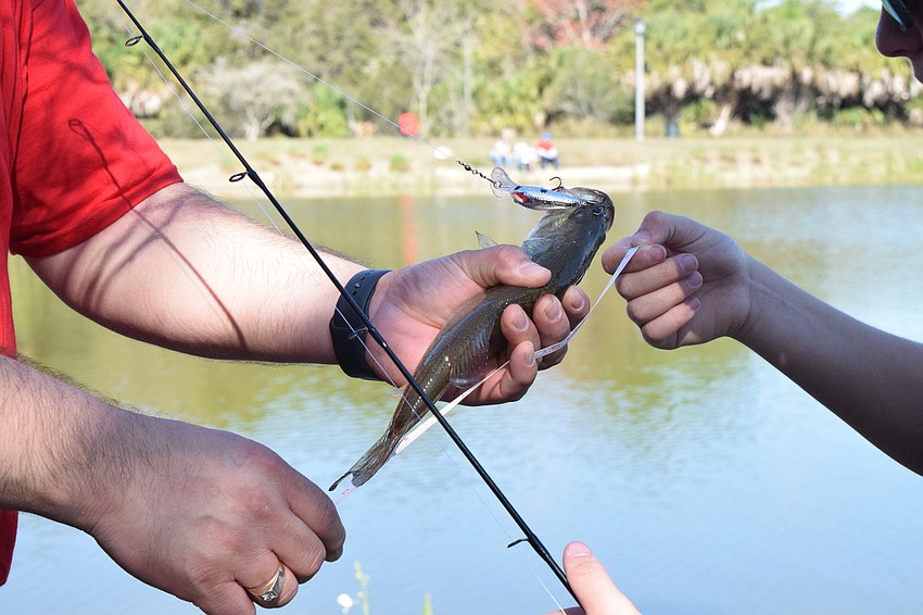 A fish is measured and recorded. The length of the fish helps determine the winners of the tournament.