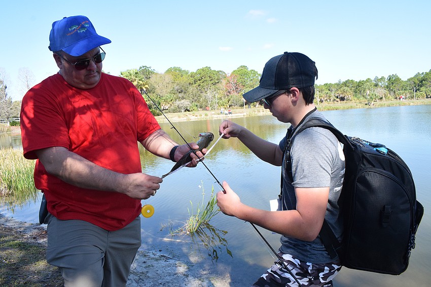 Greenbrook's Ryan Brems, who is a member of the Lakewood Ranch Anglers Club, measures a fish Lakewood Ranch's Aiden Piccirilli caught.