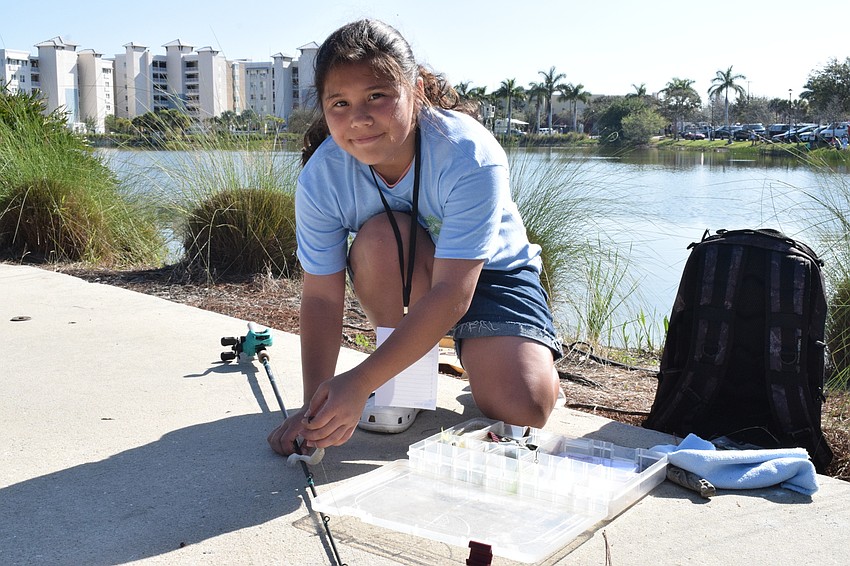 Lakewood Ranch's Caraline Milner, who is 12, puts a lure on her line. Although Milner has been fishing for four years, this year was her first time participating in the tournament.