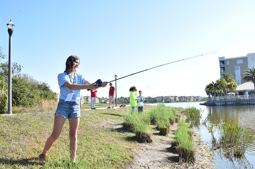 Lakewood Ranch's Sophia Siegrast, who is 11, casts her line into Lake Uihlein.