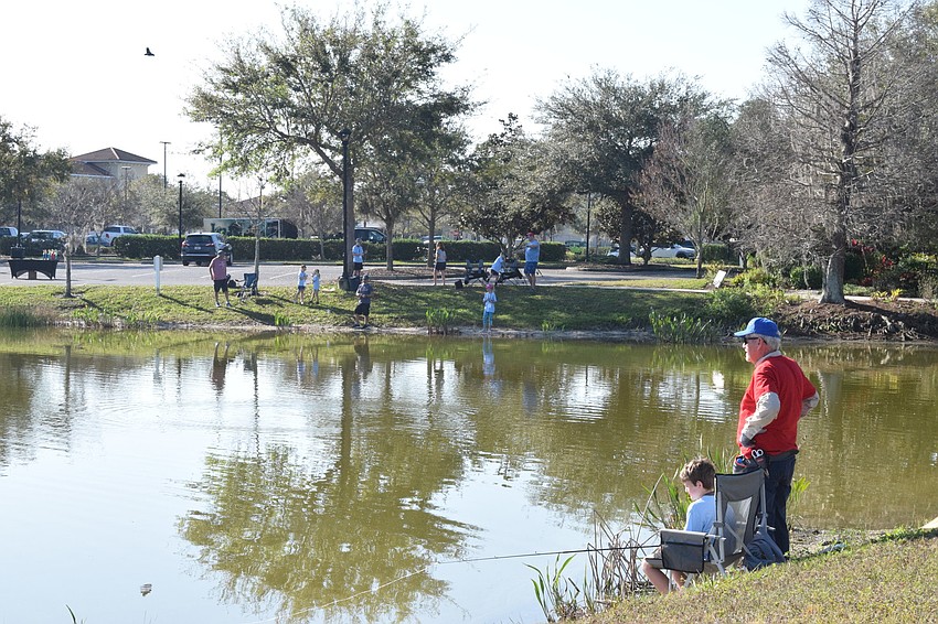 Dozens of children try their best to catch fish in hopes of winning the tournament.