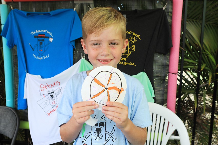 Troy Kiner paints sand dollars.
