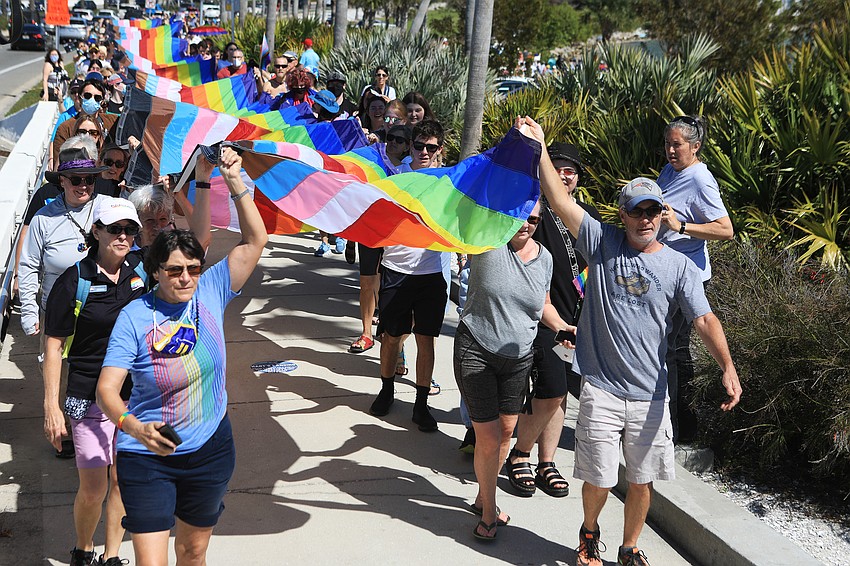 Hundreds marched with a pride flag.