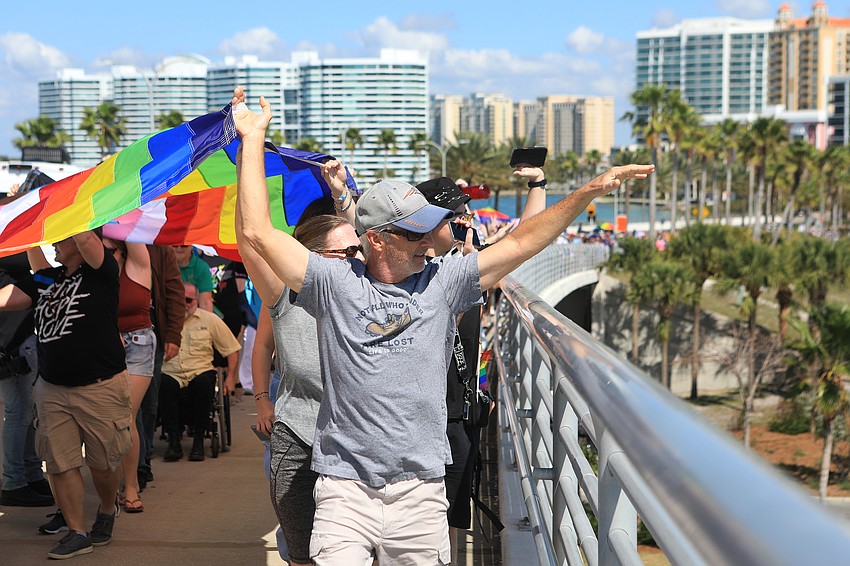 Peter Baldi waves to boats below.