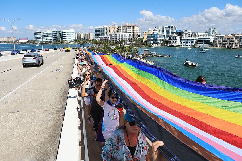 Hundreds marched with a pride flag.