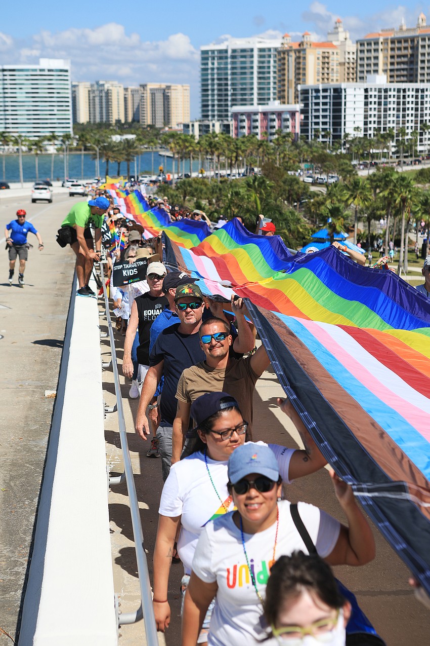 Hundreds marched with a pride flag.