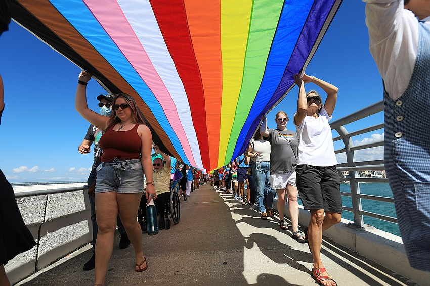 Hundreds marched with a pride flag.