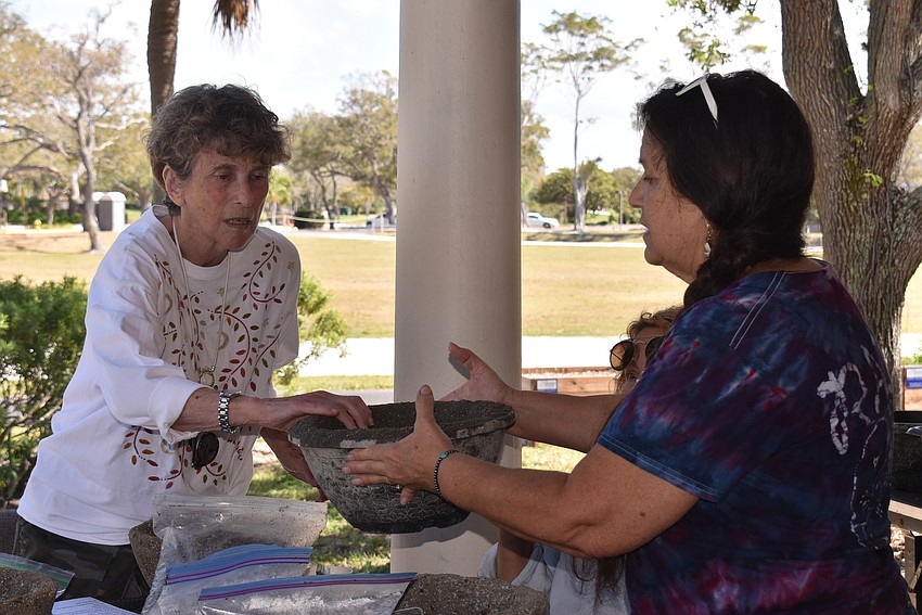 Louise Millman feels a hypertufa pot Deb Lemieux brought.