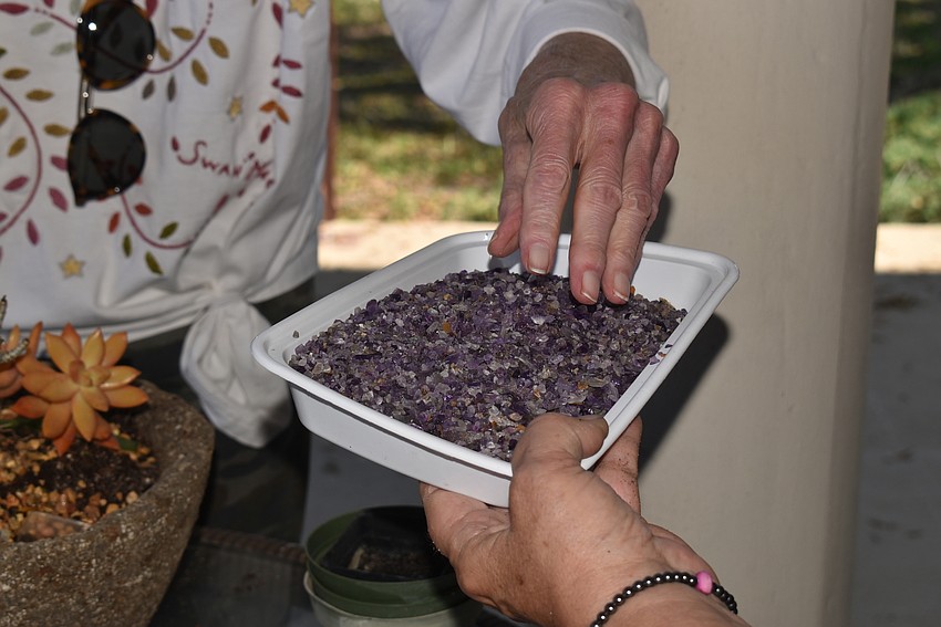 Louise Millman takes crushed amethyst to decorate her pot.