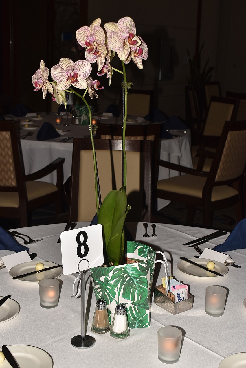 The tables were decorated with orchids as centerpieces.