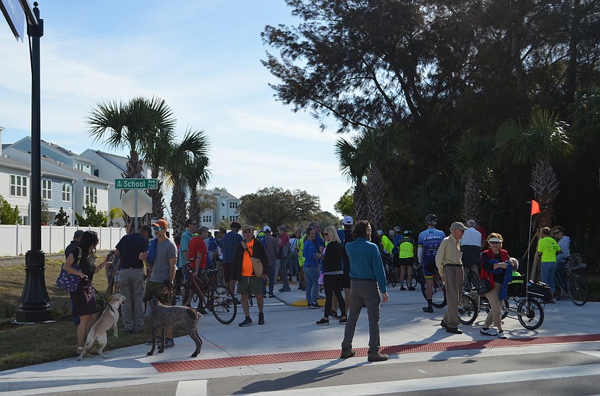 A crowd gathering in front of Legacy Trail's Segment 3 entrance at Payne Park.