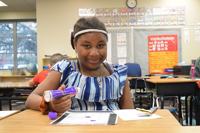 Fifth grader Rose D'Haiti finds the antonyms to words with the hopes of getting a Bingo.