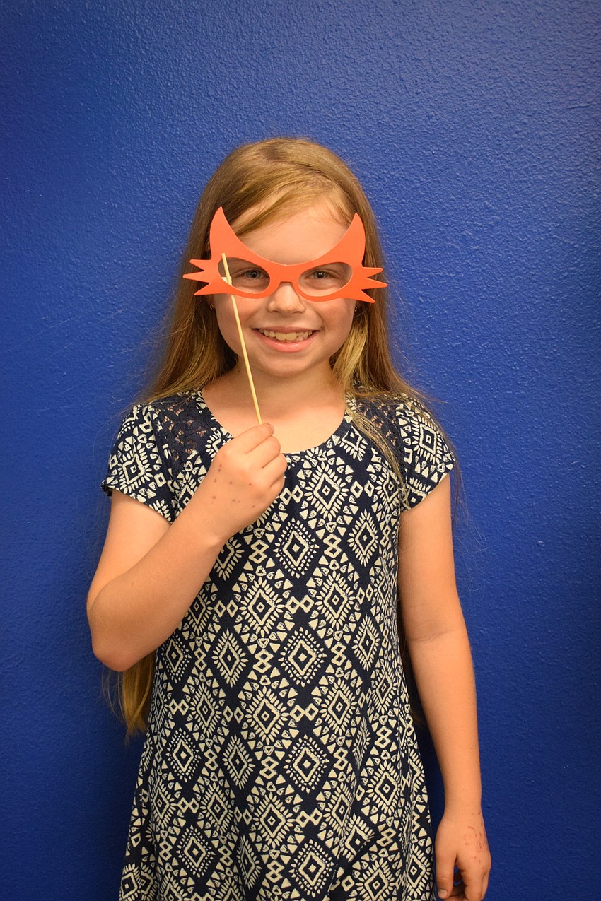 Third grader Reagan Rome gets her photo taken at the photo booth.
