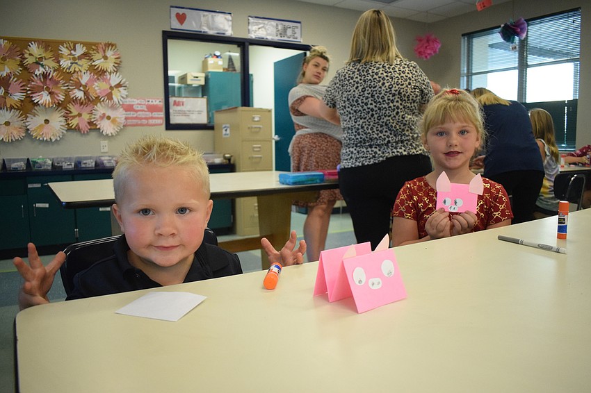 Drake Edwards, who is 2, and Vivian Edwards, who is going into kindergarten next year, show off the pigs they made.