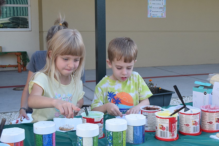 Kindergartner Leia Mackinlay and her 4-year-old brother Jaxon Mackinlay, who is in pre-K, decorate cookies.