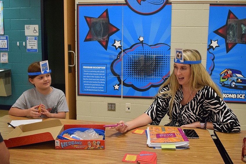 Third grader Harper Caropepe plays a game with third grade teacher Kristen Weems.