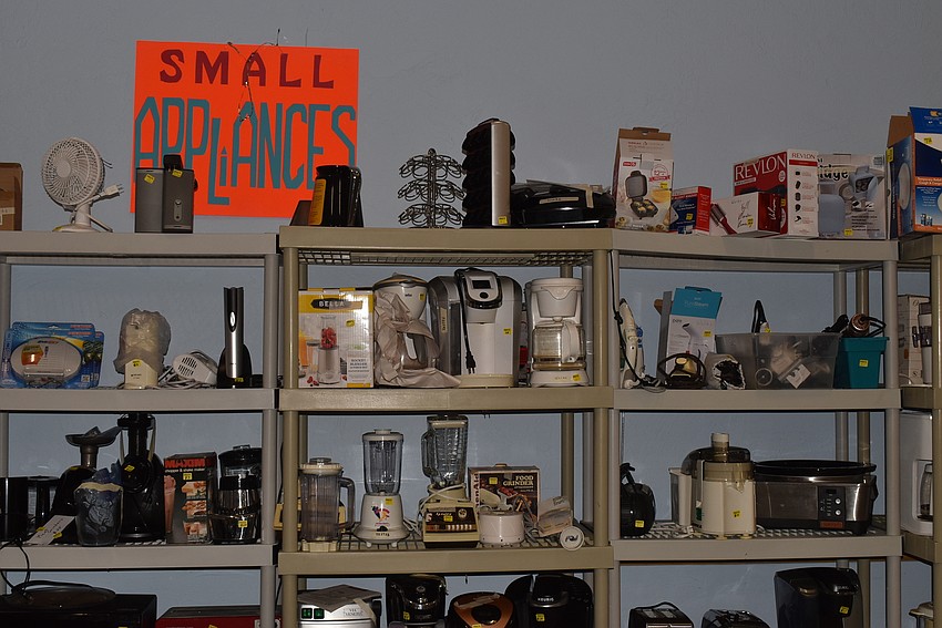 Small appliances like blenders, coffee makers and hairdryers took up half a wall.