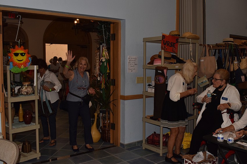 Carole Shaw waves as she enters the sale.