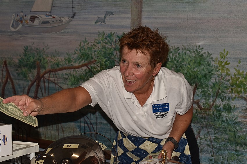 Mary Lou Ivasko gives a customer change.