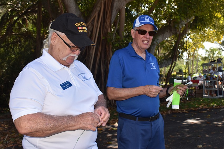 Dave Endean and Bob Soper run interference at the edge of the sale.
