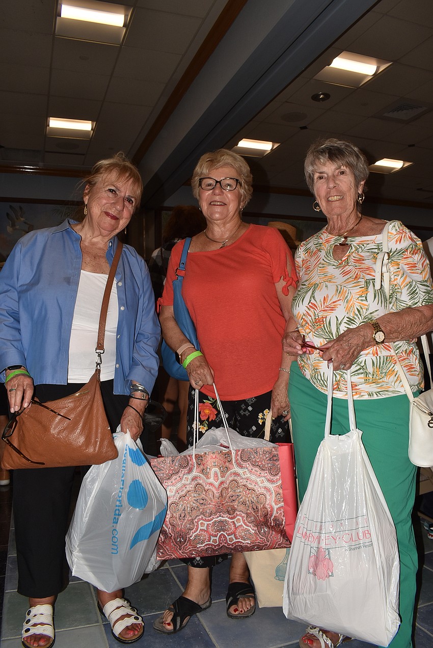 Cami O'Donnell, Doris Cory and Midge Pescatello head for the exit with their finds.
