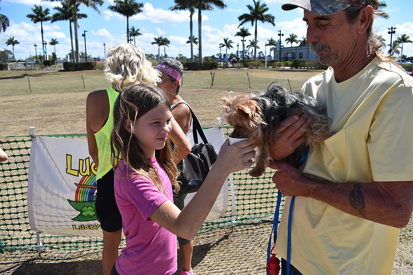 Sarasota's Lucy and James Emanuel of Sarasota give their Yorkshire terrier Sparky a little love.