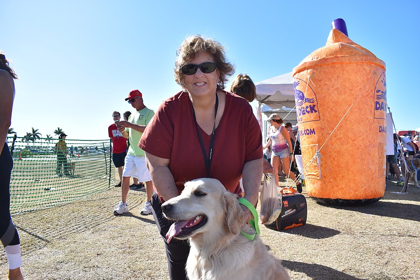 Pamela Kluge of Ellenton sits with her dog Scout, who prefers watching the other dogs run.