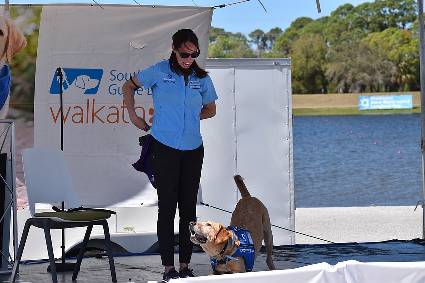 Labrador retriever Astro takes a bow for trainer Marisa Blanco of Southeastern Guide Dogs.