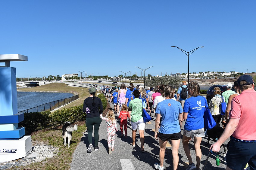 Walkers pack the sidewalk during the Southeastern Guide Dogs Walkathon at Nathan Benderson Park.