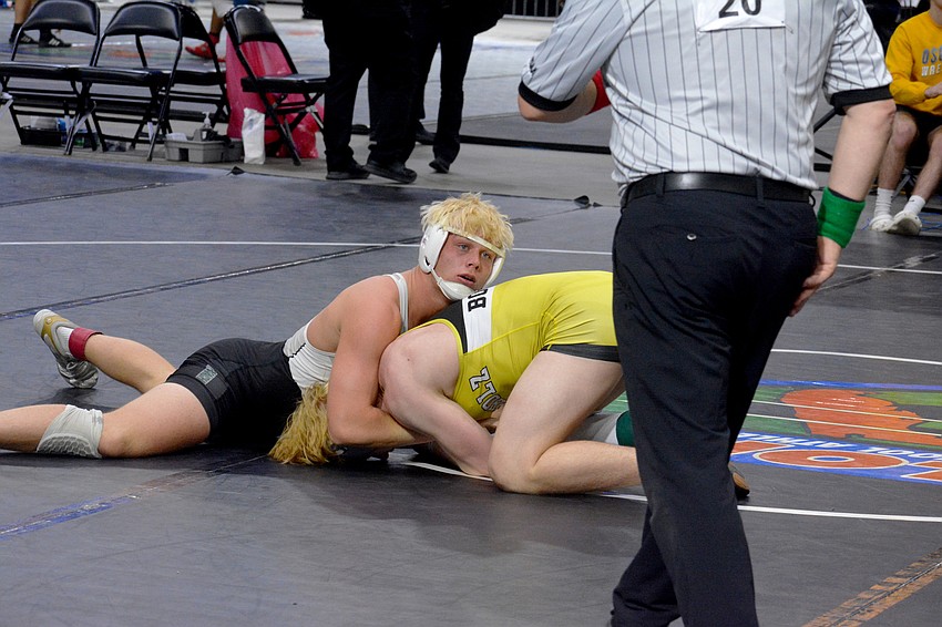 Lakewood Ranch senior Ranson Coons holds down Buchholz senior Karson Nichols. Coons would win the match and take third place in the Class 3A 182-pound division.